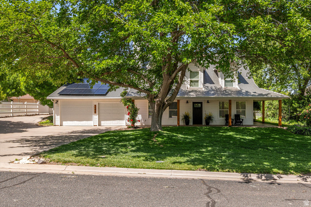 246 West Mount Charm Road Toquerville, UT 84774 - Photo 1 of 70 View of front of property with solar panels, driveway, a garage, and a porch