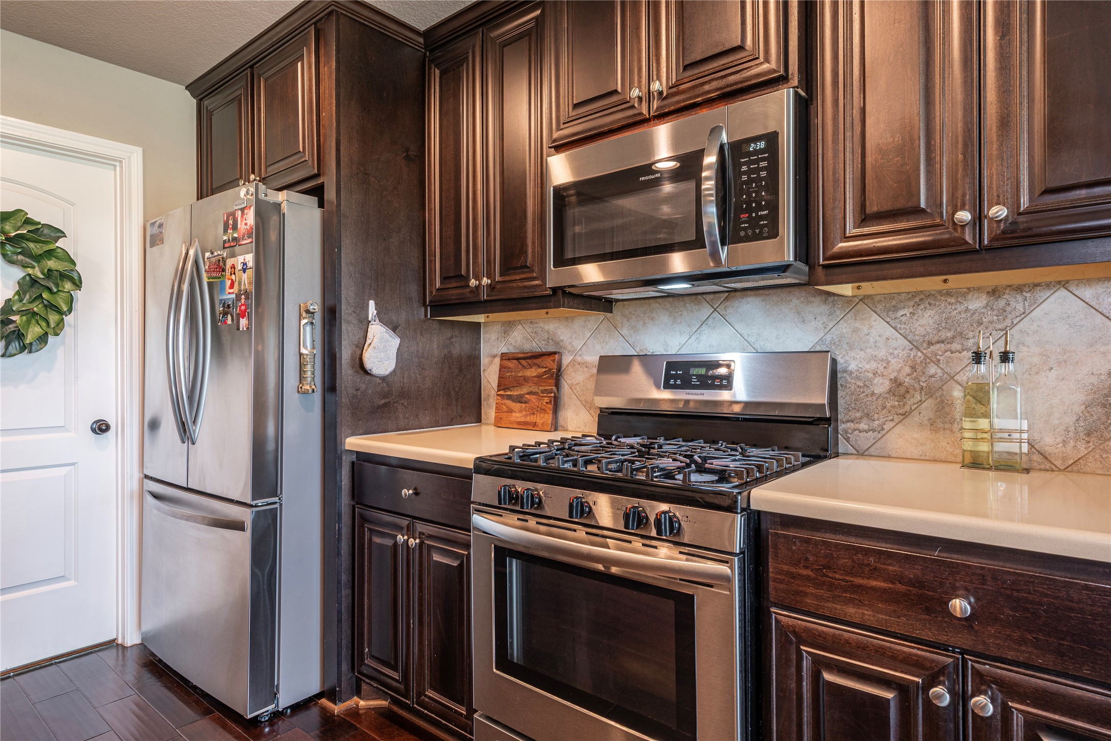 4288 FM 2546 Road El Campo, TX 77437 - Photo 13 of 26 a kitchen with stainless steel appliances granite countertop a stove microwave and refrigerator