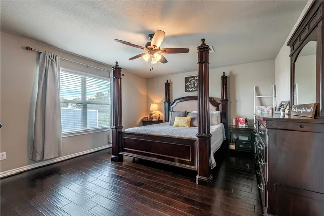 a view of a livingroom with furniture ceiling fan and wooden floor