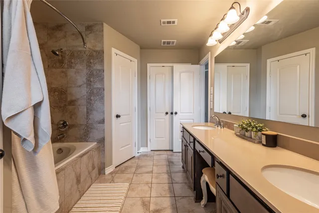 a bathroom with a sink a toilet a mirror and shower