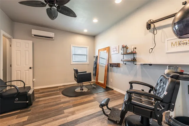 a view of a workspace with furniture and a mirror