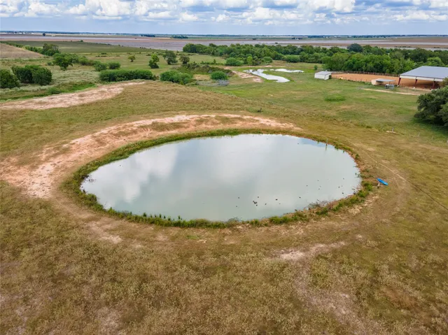 a view of a swimming pool and a yard