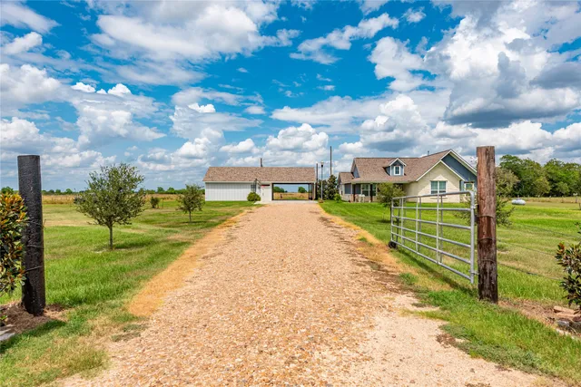 a view of a garden with a house in the background