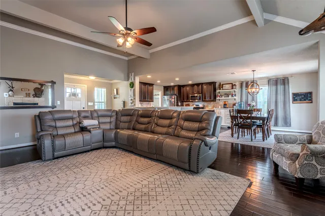 a living room with furniture and kitchen view