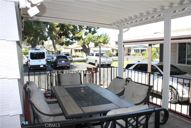 a view of a patio with table and chairs and wooden floor