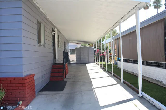 a view of a porch with chairs and potted plants