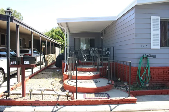 a view of balcony with two large windows and a potted plant