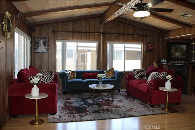 a living room with furniture couches and a chandelier