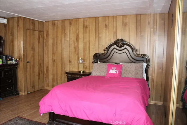 a bedroom with a bed a table and chair