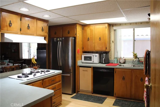a kitchen with kitchen island a sink stove and refrigerator