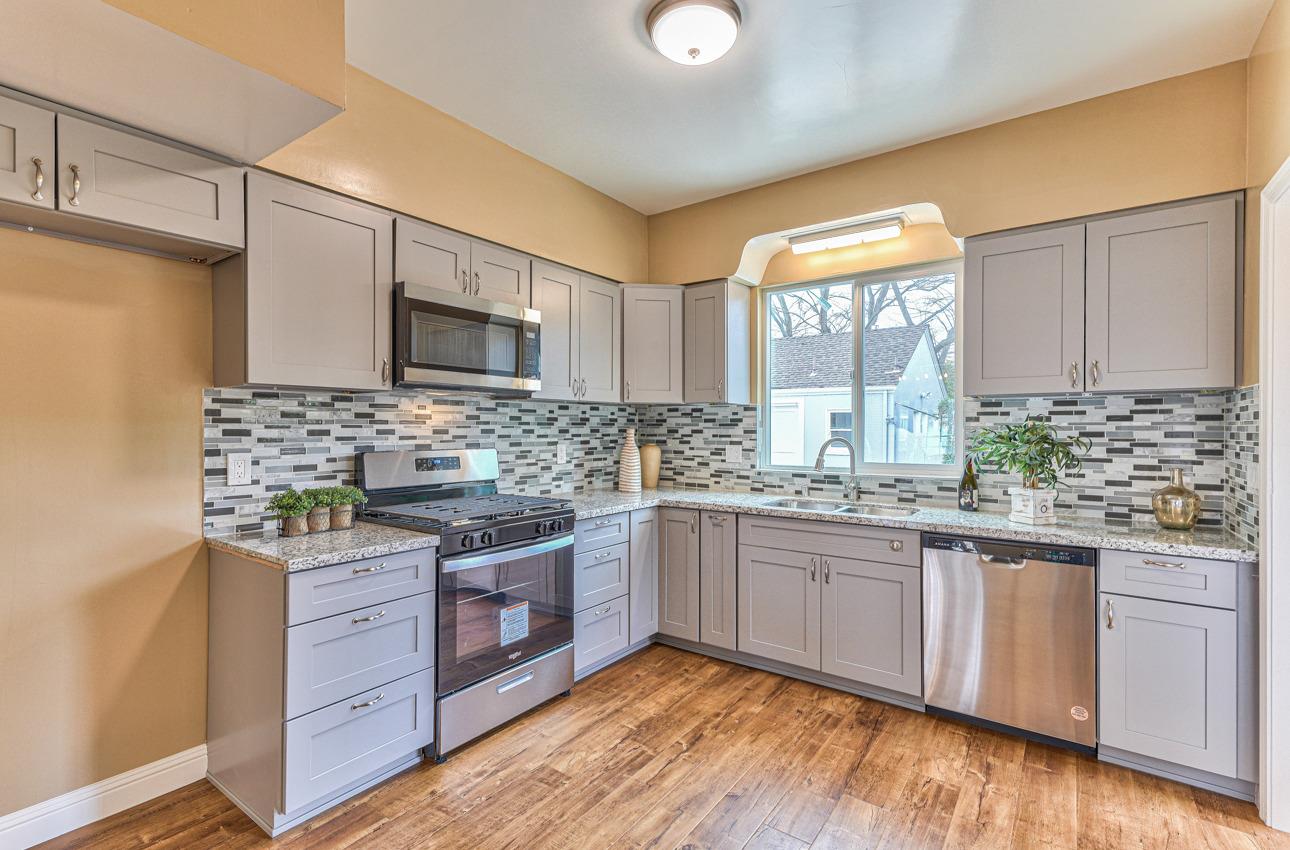 160 Lorimer Street Salinas, CA 93901 - Photo 15 of 45 a kitchen with stainless steel appliances granite countertop wooden cabinets and a stove top oven