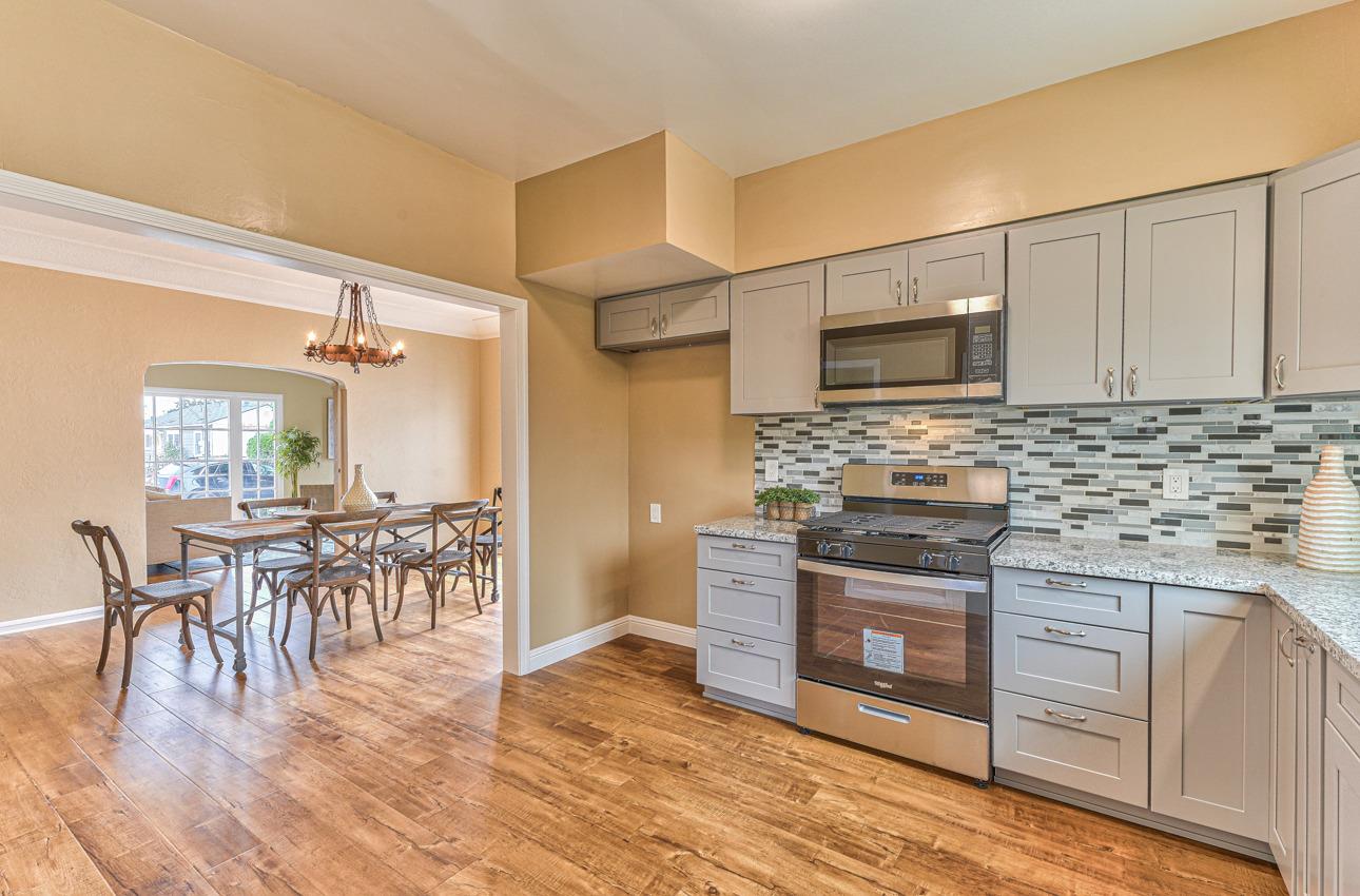 160 Lorimer Street Salinas, CA 93901 - Photo 16 of 45 a kitchen with stainless steel appliances a kitchen island hardwood floor sink stove dining table and chairs
