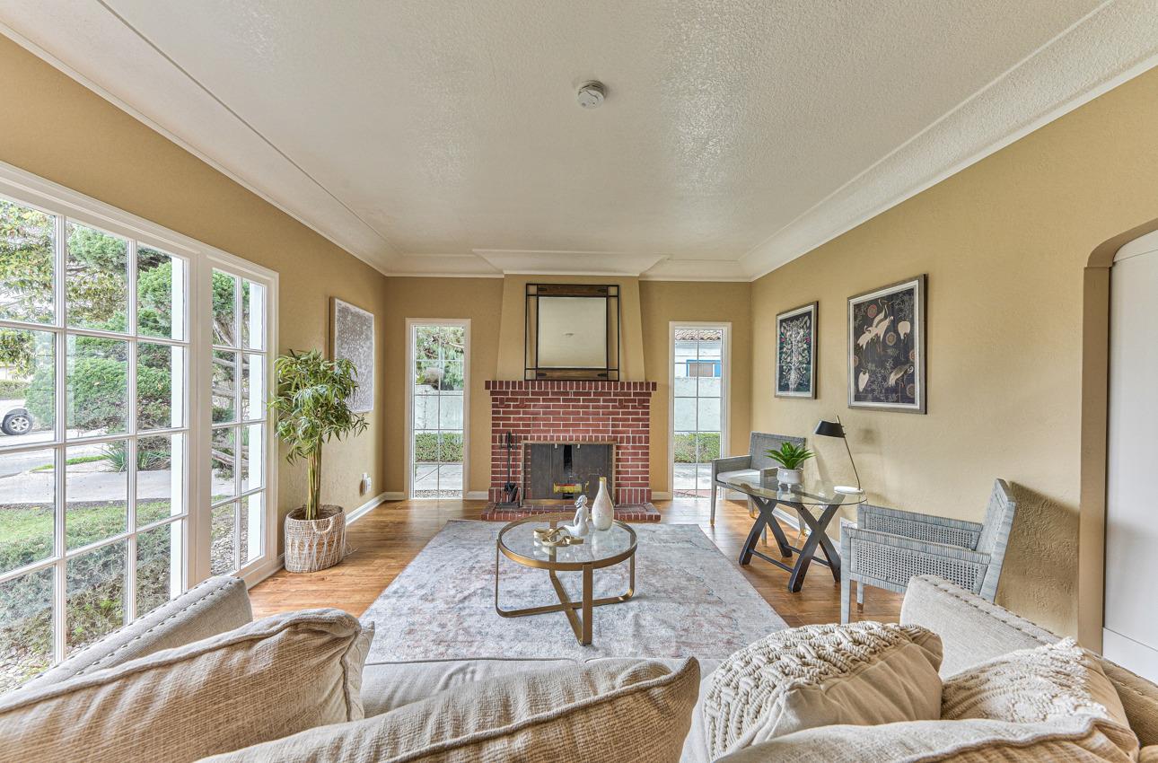 160 Lorimer Street Salinas, CA 93901 - Photo 8 of 45 a living room with furniture a fireplace and a floor to ceiling window