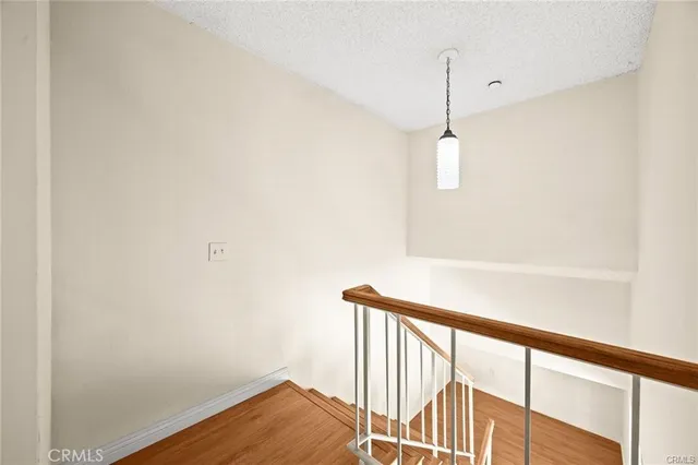 a view of a hallway with wooden floor and a window
