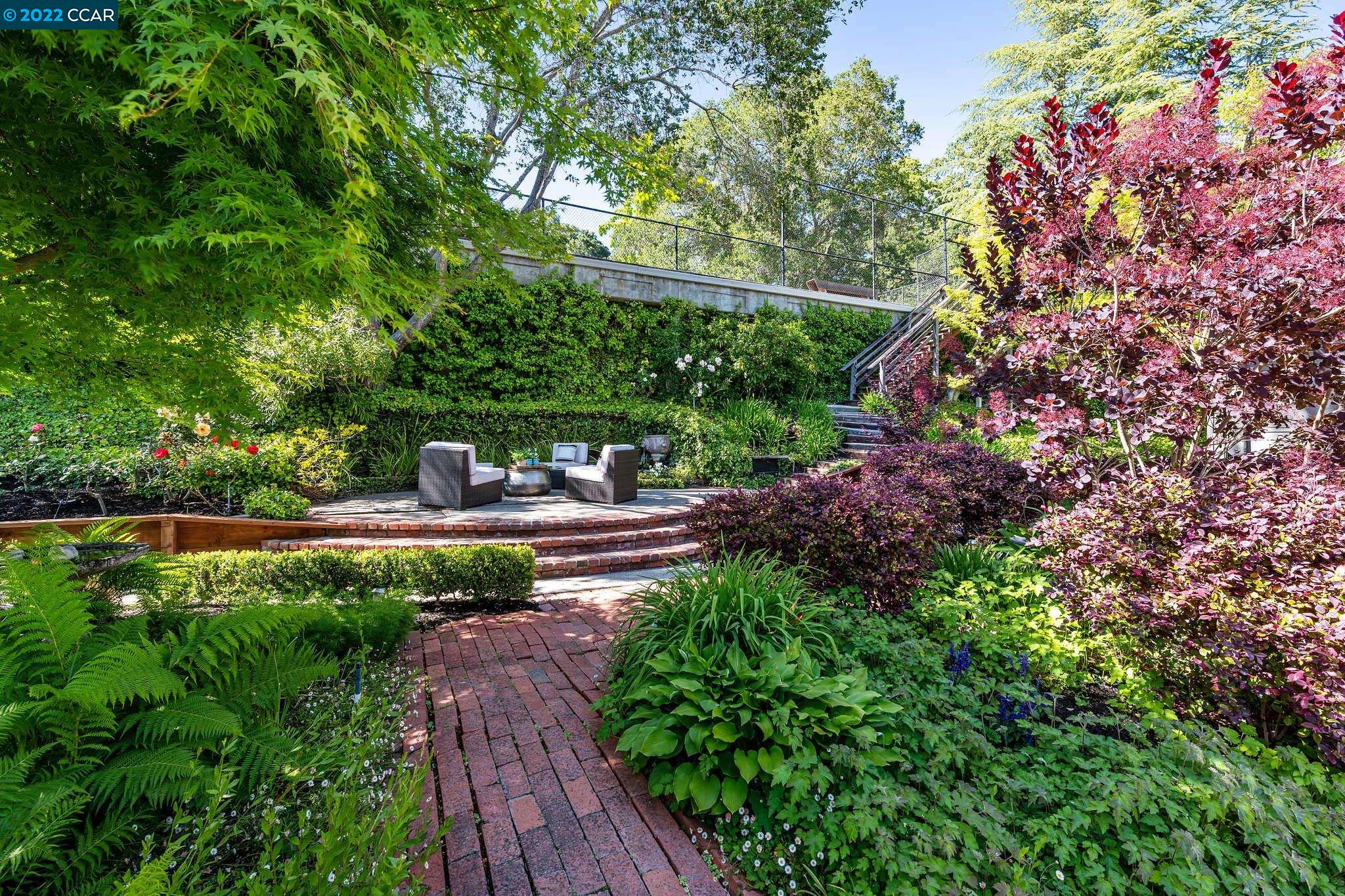 a view of a garden with sitting area