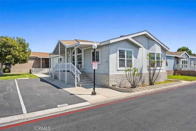 a view of a house with swimming pool and porch