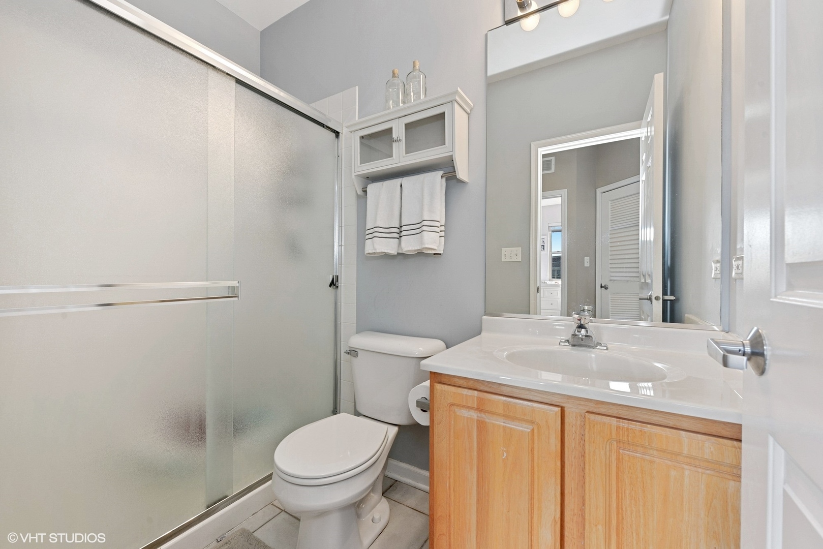 1344 North Burling Street Chicago, IL 60642 - Photo 13 of 21 a bathroom with a granite countertop sink toilet and shower