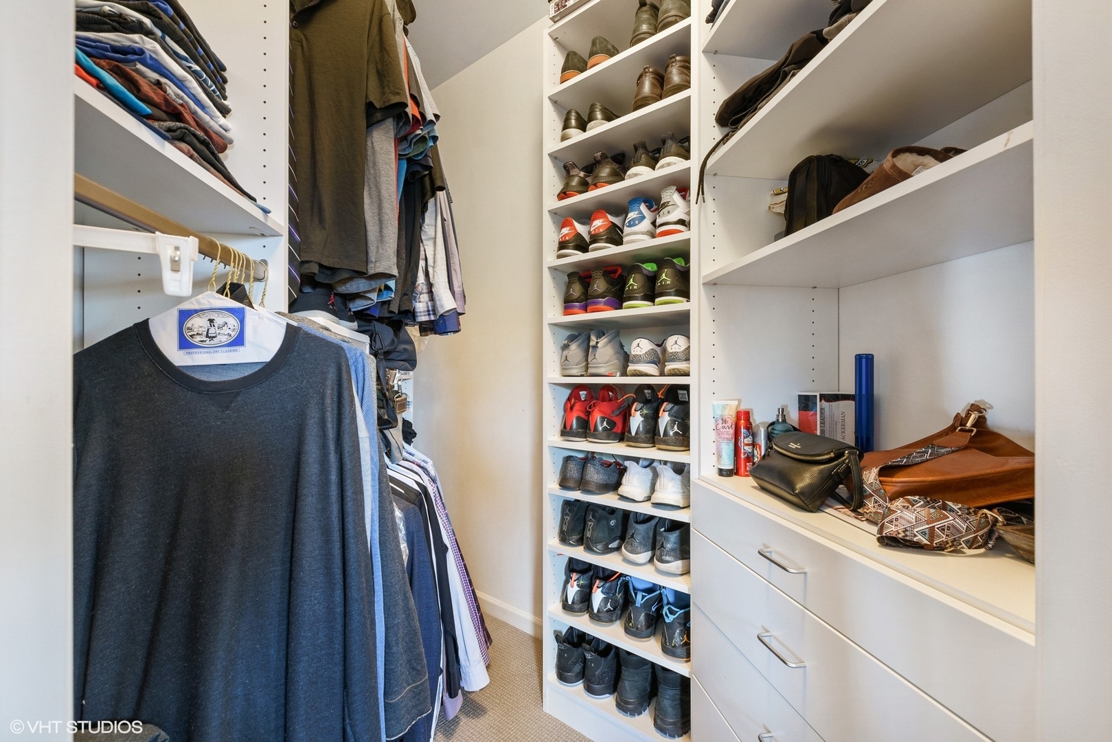 1344 North Burling Street Chicago, IL 60642 - Photo 8 of 21 a view of walk in closet with clothes and shoes