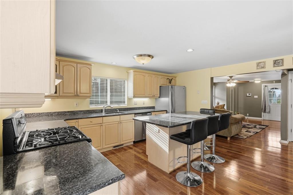 126 Leon Road Pittsburgh, PA 15220 - Photo 12 of 50 a kitchen with a counter space a sink stove and cabinets