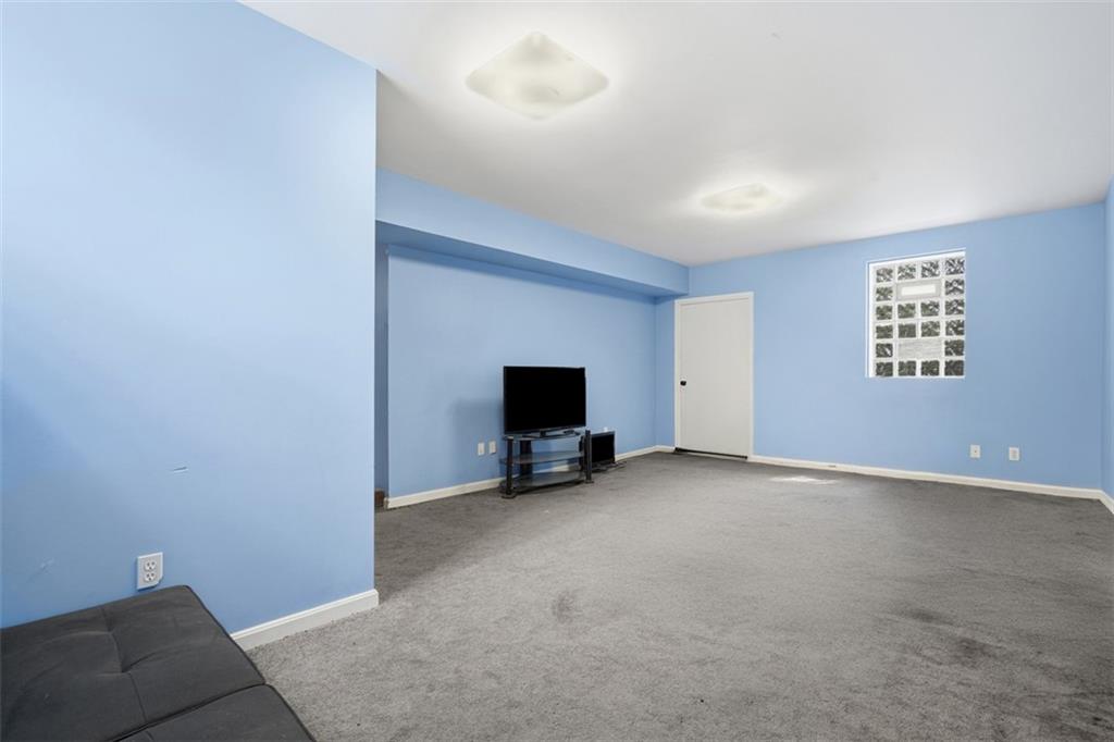 126 Leon Road Pittsburgh, PA 15220 - Photo 24 of 50 a living room with furniture and a flat screen tv