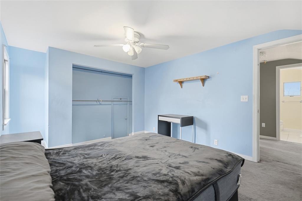 126 Leon Road Pittsburgh, PA 15220 - Photo 26 of 50 a bedroom with a bed and a chandelier