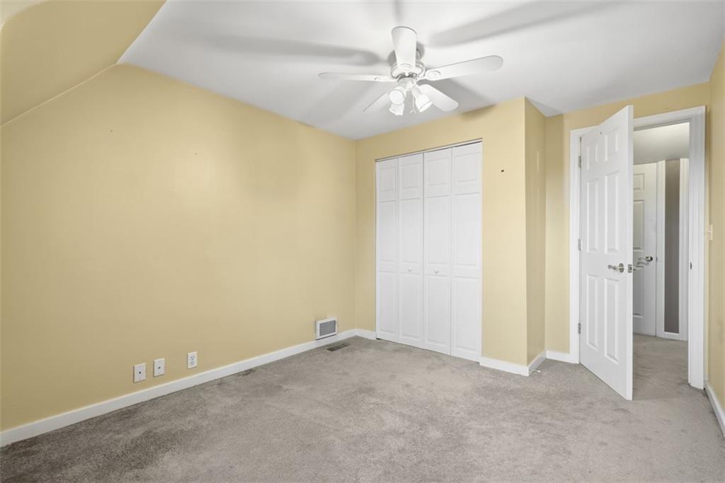 126 Leon Road Pittsburgh, PA 15220 - Photo 30 of 50 an empty room with a chandelier fan and windows