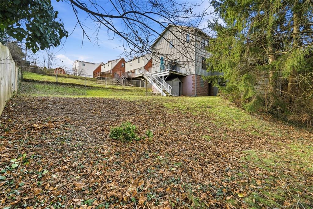126 Leon Road Pittsburgh, PA 15220 - Photo 42 of 50 a view of a backyard with plants and large trees