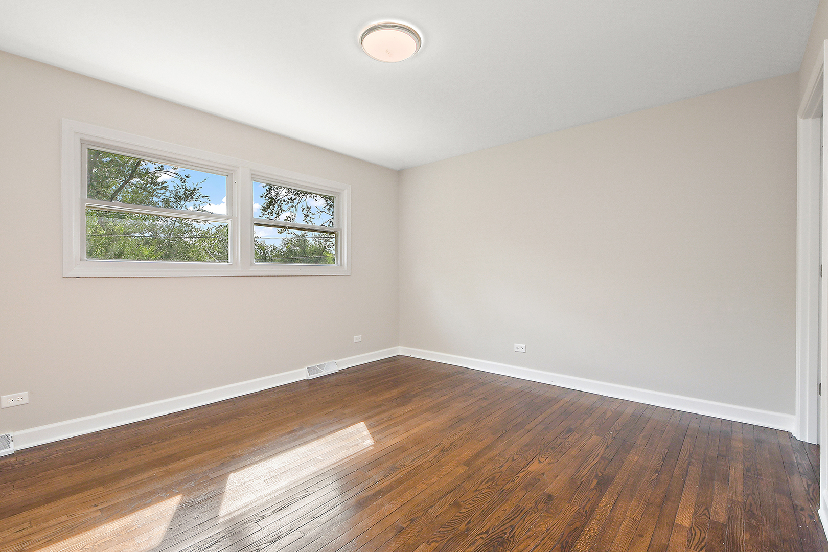 18938 Jonathan Lane Homewood, IL 60430 - Photo 13 of 33 an empty room with wooden floor and windows