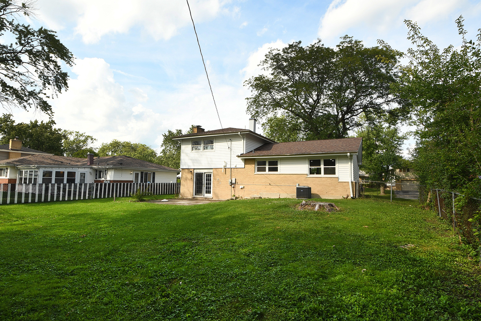 18938 Jonathan Lane Homewood, IL 60430 - Photo 22 of 33 a front view of a house with a yard and trees