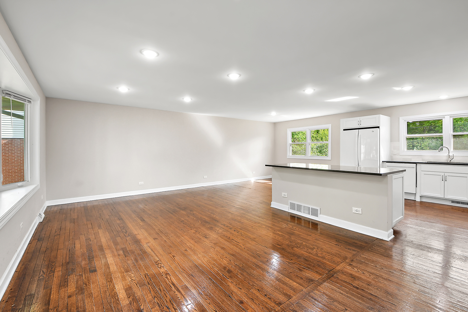 18938 Jonathan Lane Homewood, IL 60430 - Photo 6 of 33 an empty room with wooden floor and windows