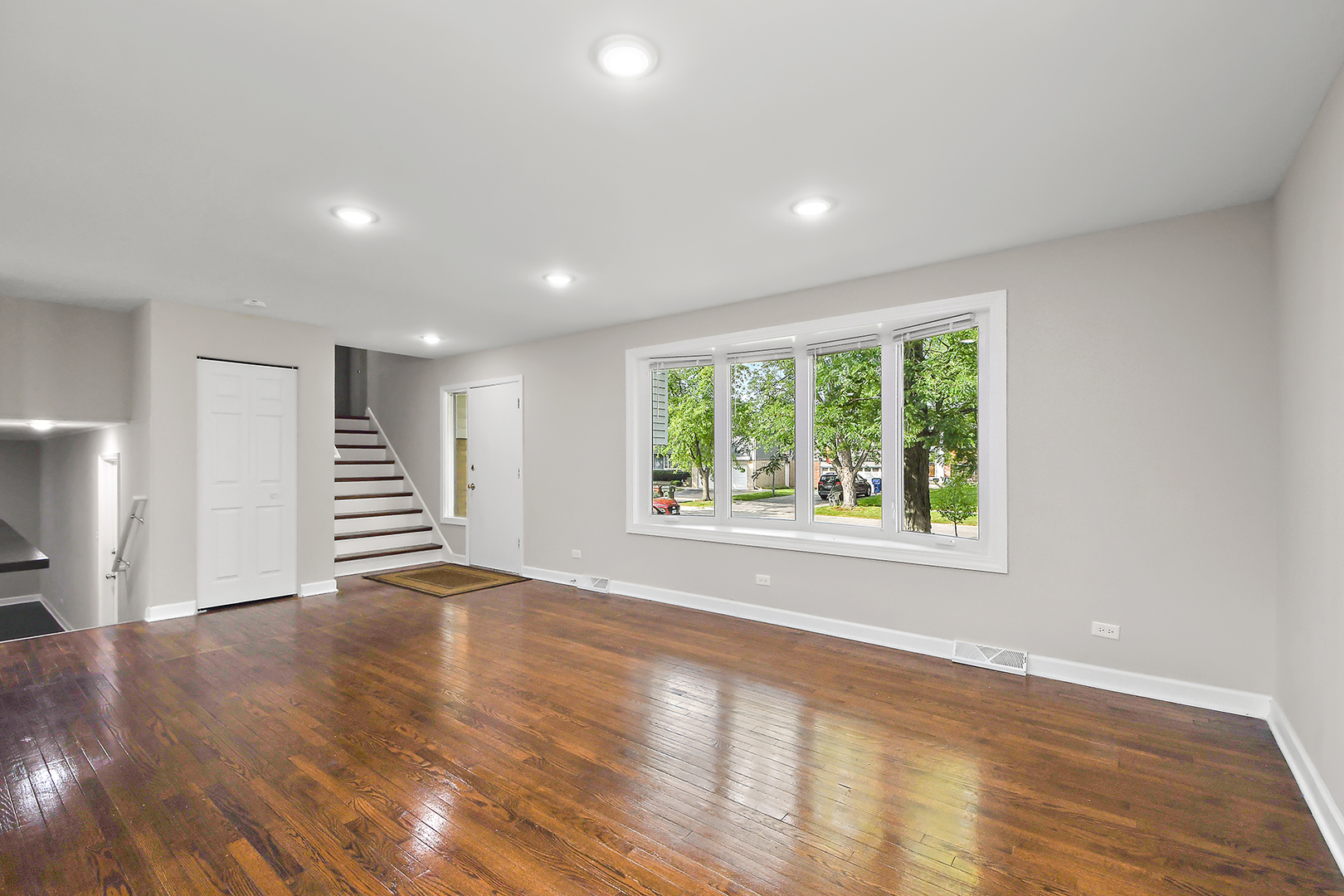 18938 Jonathan Lane Homewood, IL 60430 - Photo 9 of 33 a view of an empty room with a window and wooden floor