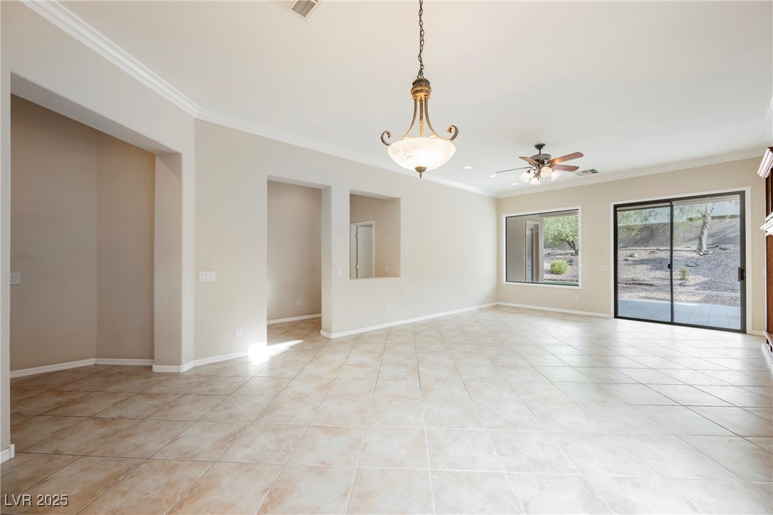 17 Caprington Road Henderson, NV 89052 - Photo 13 of 34 Unfurnished room with crown molding, light tile patterned floors, and ceiling fan