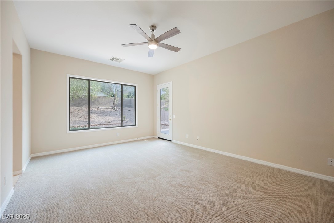 17 Caprington Road Henderson, NV 89052 - Photo 17 of 34 Unfurnished room with light carpet and ceiling fan