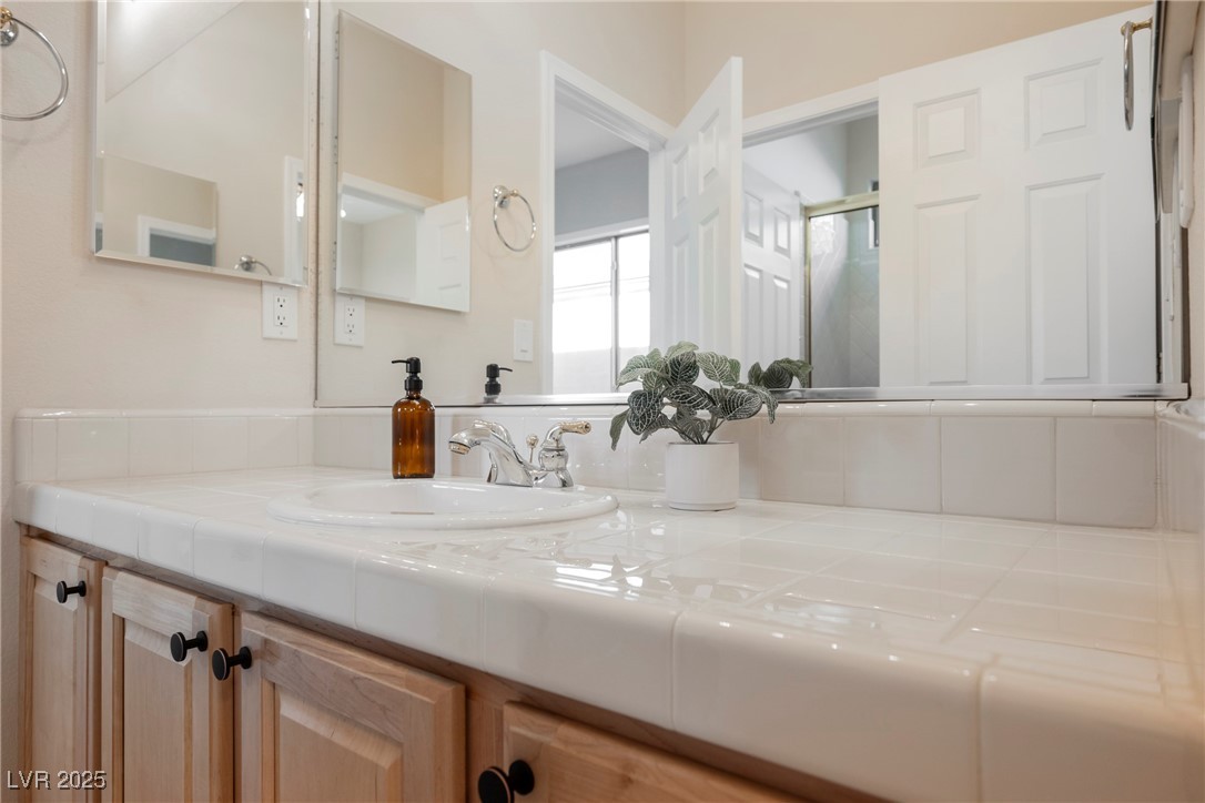 17 Caprington Road Henderson, NV 89052 - Photo 19 of 34 Bathroom featuring vanity and an enclosed shower