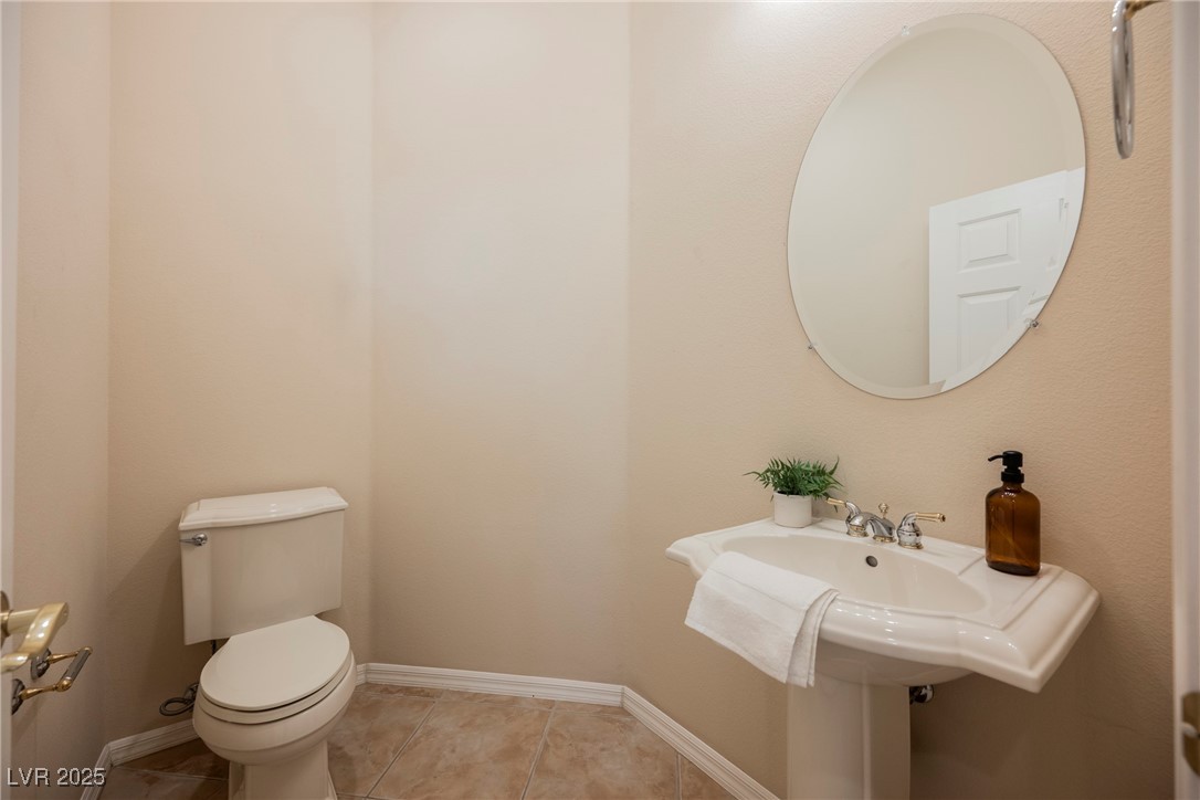 17 Caprington Road Henderson, NV 89052 - Photo 21 of 34 Half bathroom featuring toilet and tile patterned flooring