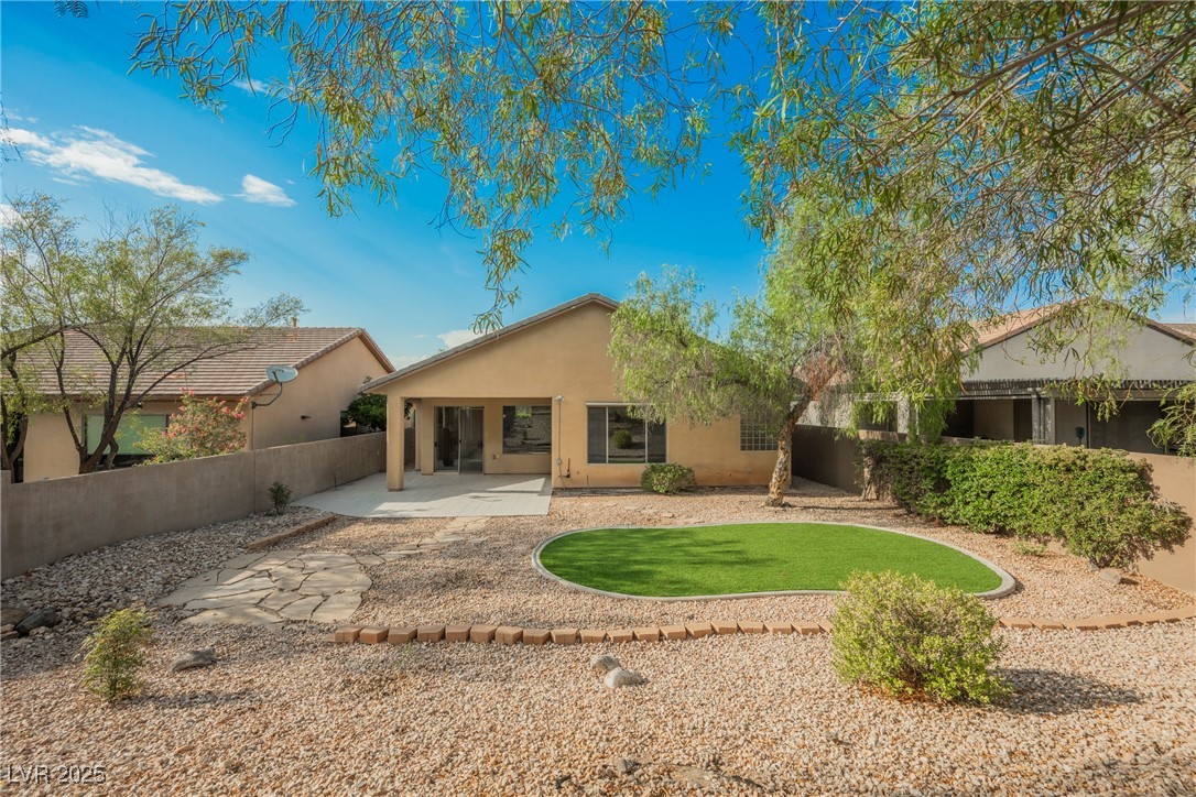 17 Caprington Road Henderson, NV 89052 - Photo 23 of 34 Back of house featuring a patio, stucco siding, and a fenced backyard