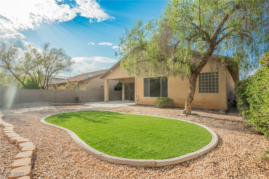 17 Caprington Road Henderson, NV 89052 - Photo 24 of 34 Back of house featuring stucco siding and a patio