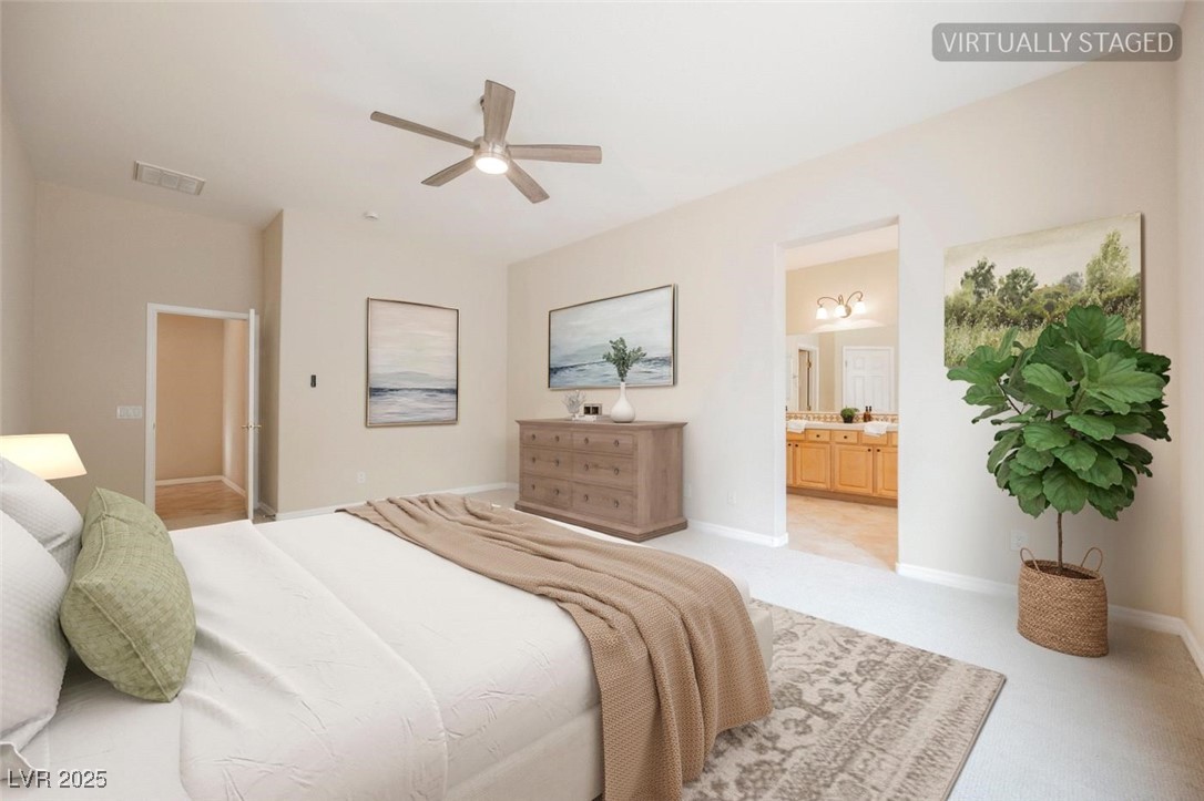 17 Caprington Road Henderson, NV 89052 - Photo 7 of 34 Bedroom with ensuite bath, light carpet, and ceiling fan