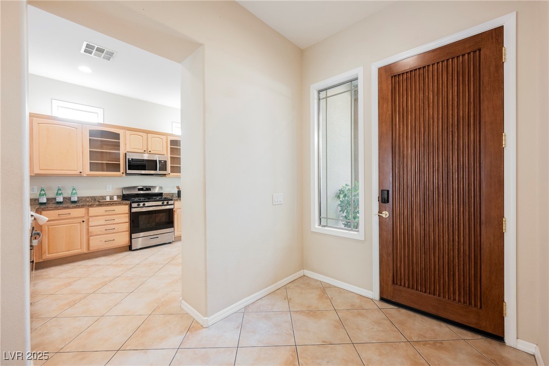 17 Caprington Road Henderson, NV 89052 - Photo 9 of 34 Entrance foyer featuring light tile patterned flooring and baseboards