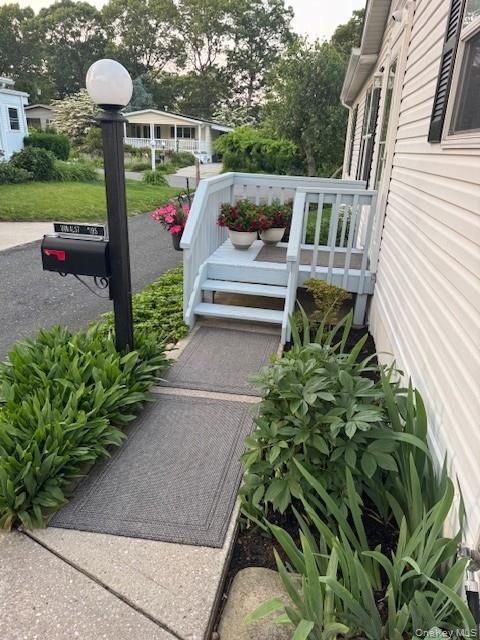 1661 Old Country Road Riverhead, NY 11901 - Photo 1 of 12 a view of a patio with table and chairs potted plants