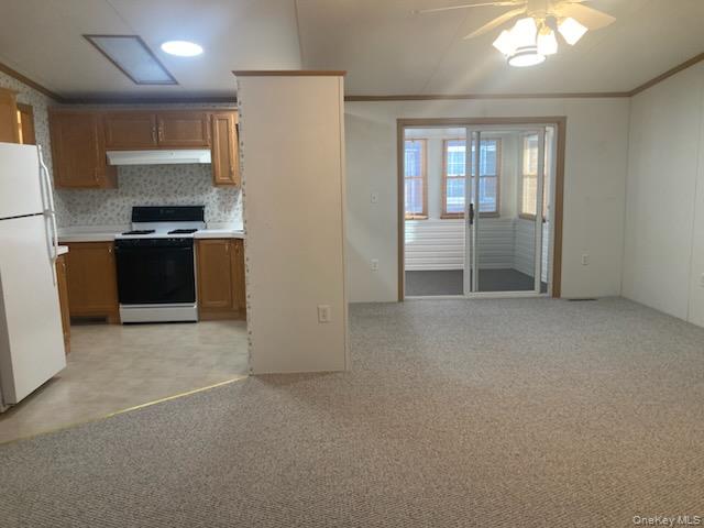 1661 Old Country Road Riverhead, NY 11901 - Photo 4 of 12 a view of an empty room with kitchen and a window