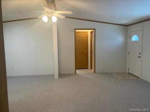 1661 Old Country Road Riverhead, NY 11901 - Photo 6 of 12 an empty room with a fan & a ceiling fan