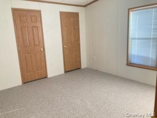 1661 Old Country Road Riverhead, NY 11901 - Photo 7 of 12 a view of an empty room with a window