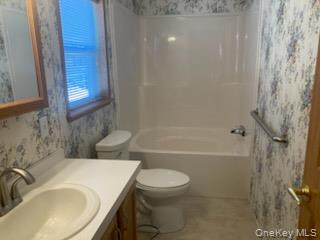 1661 Old Country Road Riverhead, NY 11901 - Photo 9 of 12 a bathroom with a sink toilet and shower