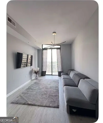 a living room with furniture and a flat screen tv