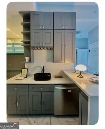 a kitchen with stainless steel appliances a sink dishwasher stove and cabinets