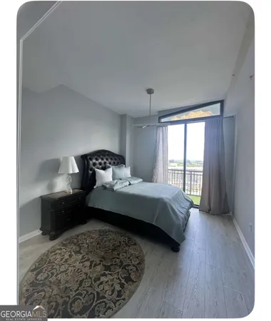 a bedroom with a bed and a large window