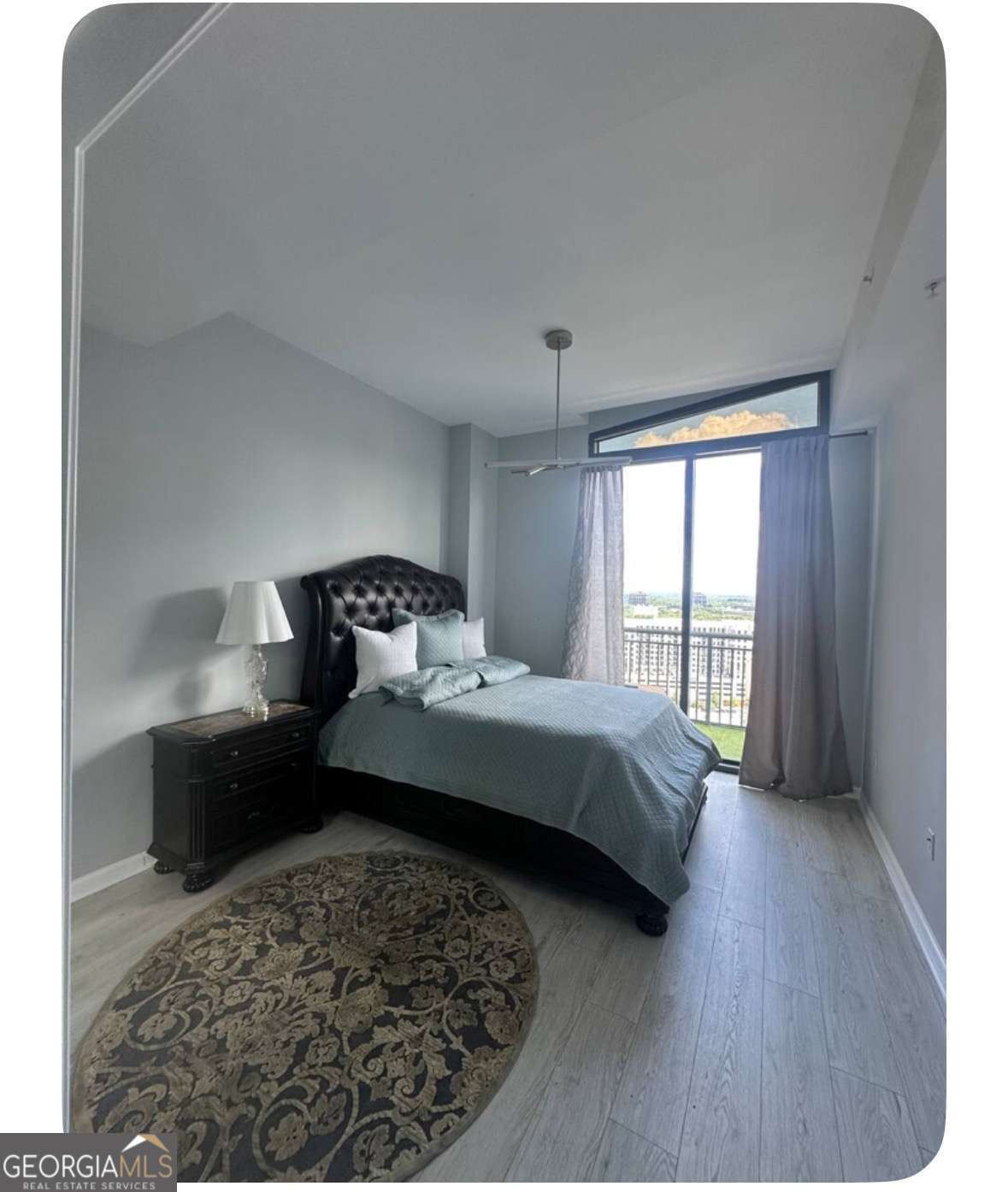 3040 Peachtree Road Northwest, Unit 1913 Atlanta, GA 30305 - Photo 6 of 12 a bedroom with a bed and a large window