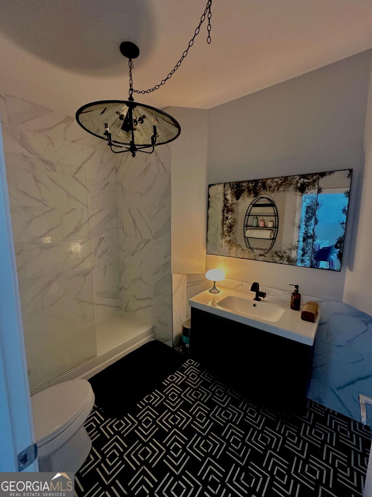 3040 Peachtree Road Northwest, Unit 1913 Atlanta, GA 30305 - Photo 7 of 12 a bathroom with a sink and a mirror