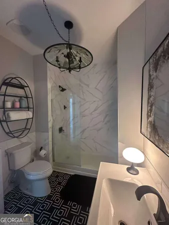 a bathroom with a sink toilet and shower